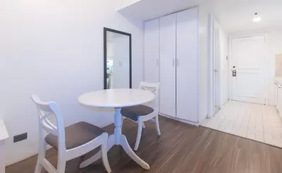 a white table and chairs in a room at RedDoorz at MPT Suites in Manila