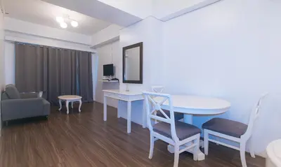 a room with a table and a chair and a table and a table at RedDoorz at MPT Suites in Manila