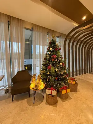 a christmas tree in a room with a couch and a chair at Obetskie's Haven Condotel in Manila