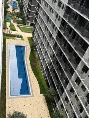 an overhead view of a large apartment building with a swimming pool at Obetskie's Haven Condotel in Manila