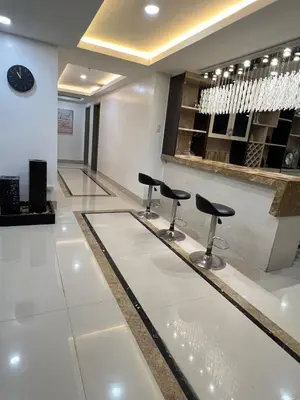 a bar with black stools in a white room at R&R Entire Rental Unit in Manila