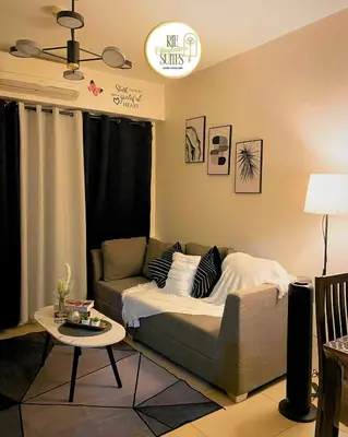 a living room with a couch and a table at RJE Staycation Suites Mall of Asia near Airports in Manila