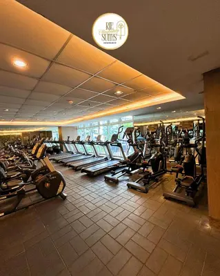 a gym with a lot of treadmills in a building at RJE Staycation Suites Mall of Asia near Airports in Manila