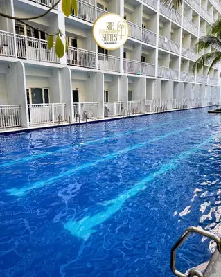 a large swimming pool in the middle of a hotel at RJE Staycation Suites Mall of Asia near Airports in Manila