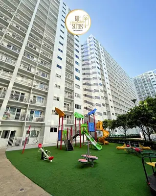 a playground in front of a large building at RJE Staycation Suites Mall of Asia near Airports in Manila