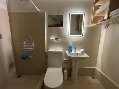 a small bathroom with a toilet and a sink at Berkeley Suites, Silang Cavite in Silang
