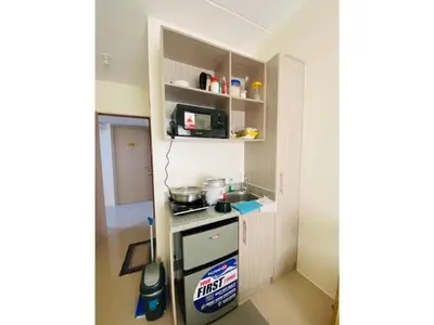 a small kitchen with a stove and a microwave at Fully Furnished Condo for Rent in Manila