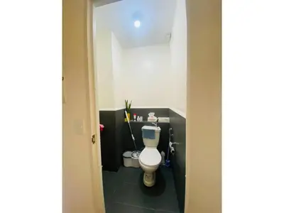 a bathroom with a white toilet in a room at Fully Furnished Condo for Rent in Manila