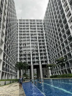 a person standing in front of a large building at Staycation Near MOA, SMX Convention Center, DFA in Manila