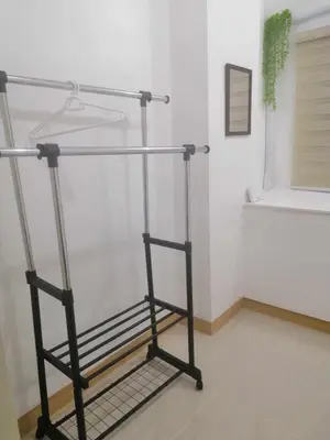 a metal rack in the corner of a room at South Residence Condo Las Pinas, Manila in Manila
