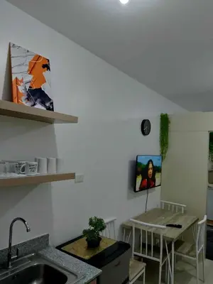 a kitchen with a sink and a table in a room at South Residence Condo Las Pinas, Manila in Manila