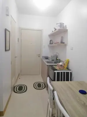 a small kitchen with a table and a stove at South Residence Condo Las Pinas, Manila in Manila