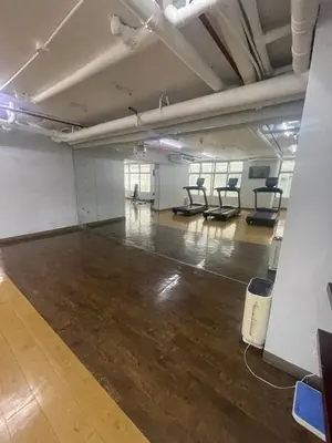 an empty room with a gym with chairs in it at Makati City Antel Spa Residences 2707 in Manila