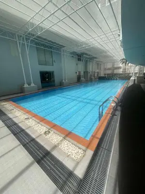 a large swimming pool in a large building at Makati City Antel Spa Residences 2707 in Manila