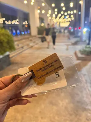 a person holding a piece of food in a bag at Chic Unit with Balcony - Free wifi & netflix across Naia Terminal 3 Airport in Manila