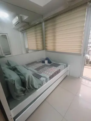 a small bed in a room with a window at Shell Residences in Manila