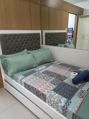 a bedroom with a bed with a quilt on it at Shell Residences in Manila