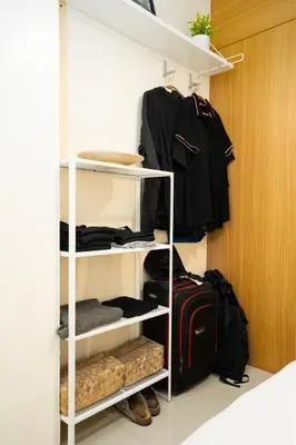a closet with a white shelving unit with luggage at Brand New Unit Shell Residences 1BR Near MOA NAIA in Manila