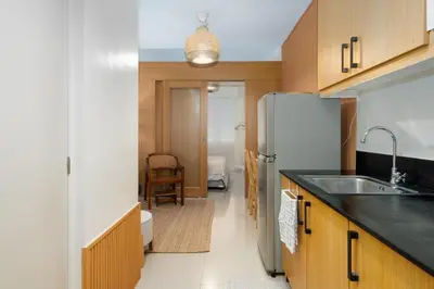 a kitchen with a sink and a refrigerator at Brand New Unit Shell Residences 1BR Near MOA NAIA in Manila