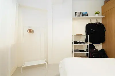 a white room with a bed and a closet at Brand New Unit Shell Residences 1BR Near MOA NAIA in Manila