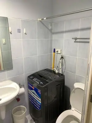 a small bathroom with a toilet and a sink at MOA Staycation - by Marites in Manila