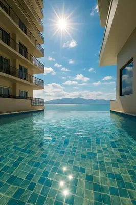 a swimming pool with a view of the water at Sophisticated City Escape Steps from Solaire & City of Dreams in Manila