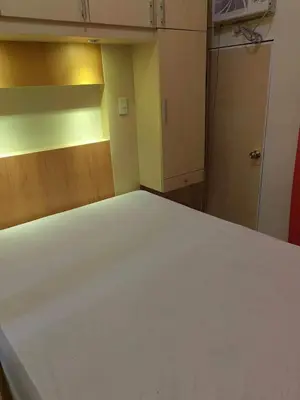 a bedroom with a white bed in a room at Chateau Elysee A11 near bar resto mall Airport in Manila