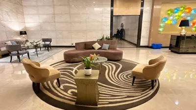 a lobby with a couch and two chairs and a table at AdahkuMaya Luxury Suites in Manila