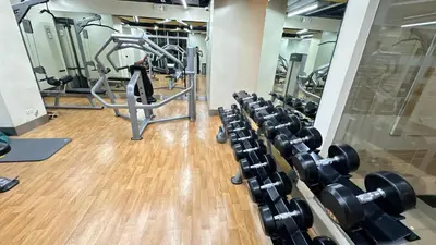 a gym with several rows of tread machines at AdahkuMaya Luxury Suites in Manila