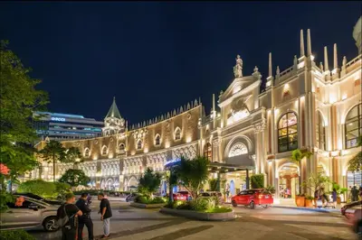 a large building with people standing outside of it at night at AdahkuMaya Luxury Suites in Manila
