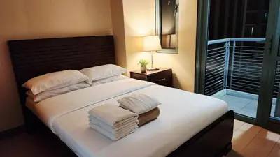a bedroom with a large bed with towels on it at Casa Antonio at 8L Two Palm Tree Beside NAIA3 in Manila
