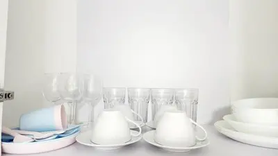 a group of glasses and plates on a table at Casa Antonio at 8L Two Palm Tree Beside NAIA3 in Manila