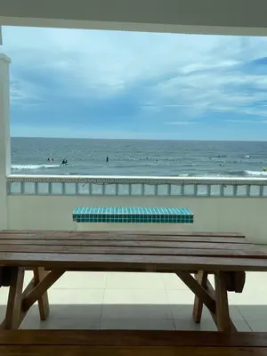a wooden bench sitting on top of a beach at Joyce Condo unit Sea Residences in Manila