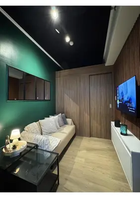 a living room with a couch and a flat screen tv at Cozy Urban Staycation Condo Unit in Manila