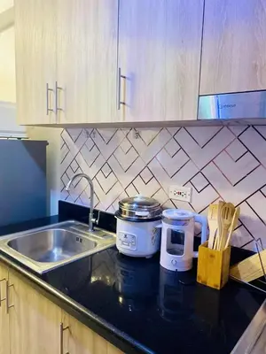 a kitchen with a sink and a counter top at LiCa Place 2 in Manila