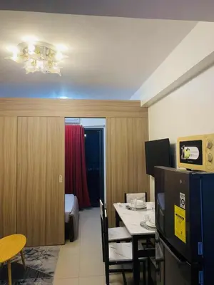 a room with a table and a room with a bedroom at LiCa Place 2 in Manila