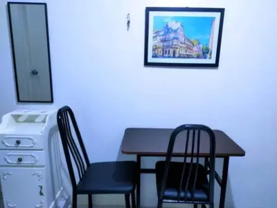 a dining room table with two chairs and a picture on the wall at Eurica transient Inn in Manila