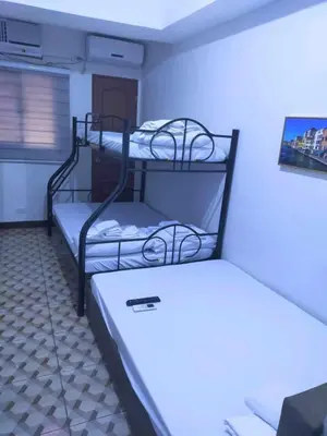 a room with two bunk beds in a room at Eurica transient Inn in Manila