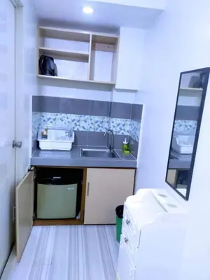 a small kitchen with a sink and a counter at Eurica transient Inn in Manila