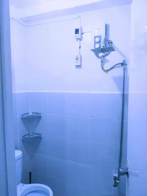a bathroom with a shower and a toilet in it at Eurica transient Inn in Manila