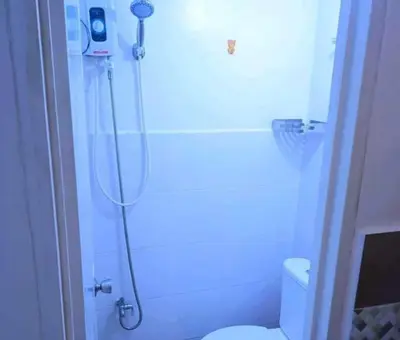 a bathroom with a shower with a toilet and a shower head at Eurica transient Inn in Manila