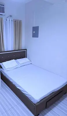 a bed in a room with a blue light at Eurica transient Inn in Manila