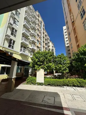 a large apartment building with a sign in front of it at Casa Chloe at Holland Park in Biñan