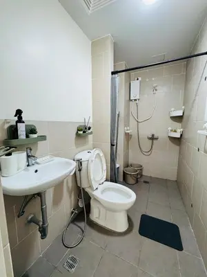 a bathroom with a toilet and a sink at Casa Chloe at Holland Park in Biñan