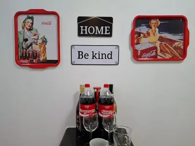 a table with two cocacola bottles on a wall at CocaCola Studio Unit McKinley in Manila