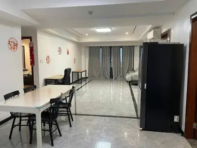 a dining room with a table and chairs and a living room at \u51b0\u5c9b\u5047\u65e5\u516c\u5bd3 in Manila