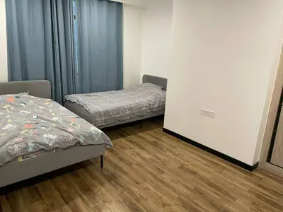 a room with two beds and a sliding door at \u51b0\u5c9b\u5047\u65e5\u516c\u5bd3 in Manila