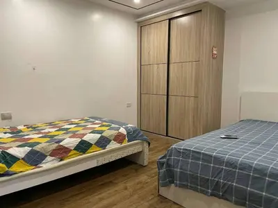 a bedroom with a bed and a wooden cabinet at \u51b0\u5c9b\u5047\u65e5\u516c\u5bd3 in Manila