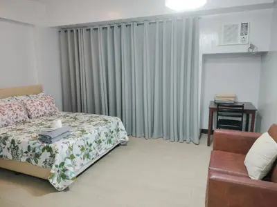 a living room with a bed and a couch at Bb Drew Rooms Near Airports in Manila