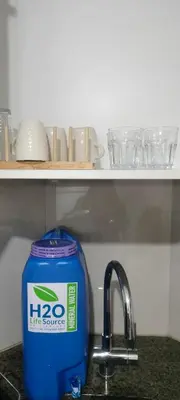 a blue container sitting next to a kitchen sink at Bb Drew Rooms Near Airports in Manila